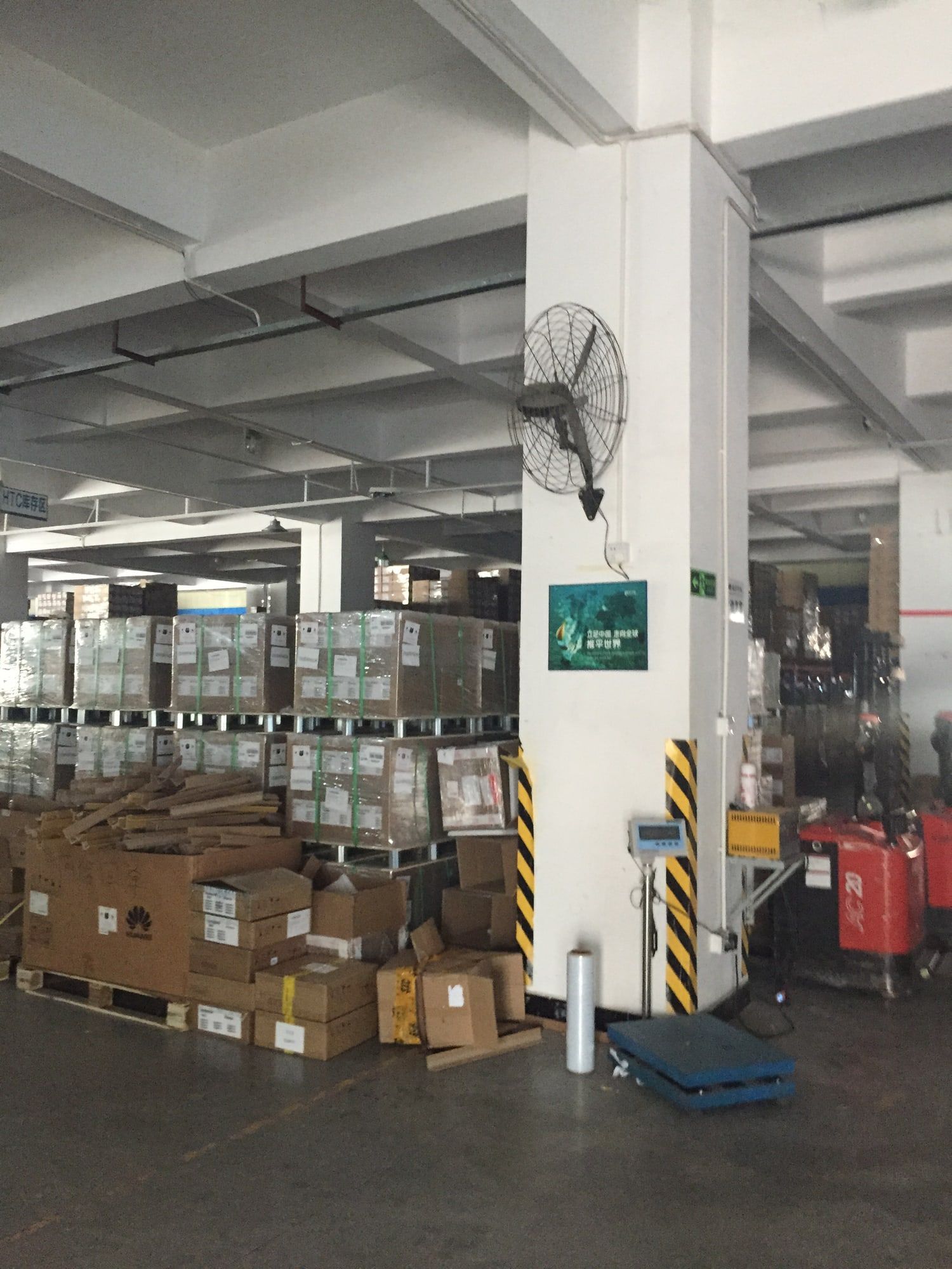 Pallets of wrapped cartons stacked on a warehouse floor.